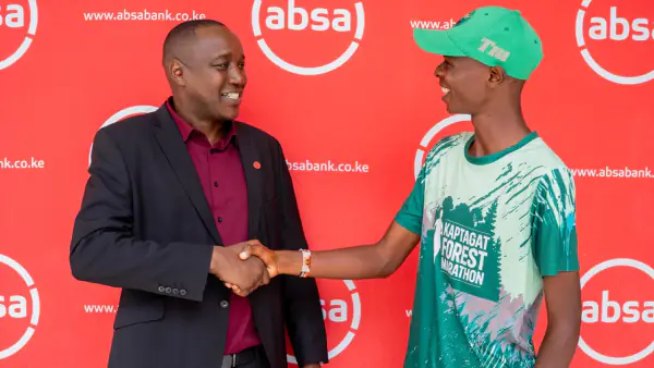Absa Bank Kenya Regional Manager Timothy Kosgey handshakes a local athlete during the launch of the inaugural Absa Eldoret City Run.