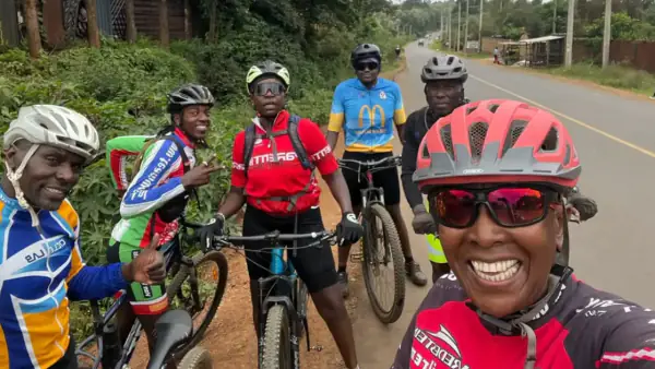 Joy Riders Kenya cyclists pausing for a selfie mid-ride on 27 May 2026