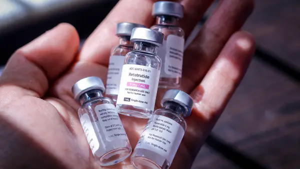 Vials of retatrutide held in a hand, representing the weight-loss peptide's growing use in Kenya